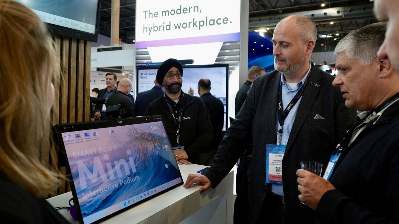 The SMART Board Mini featured at ISE 2025 surrounded by business professionals.