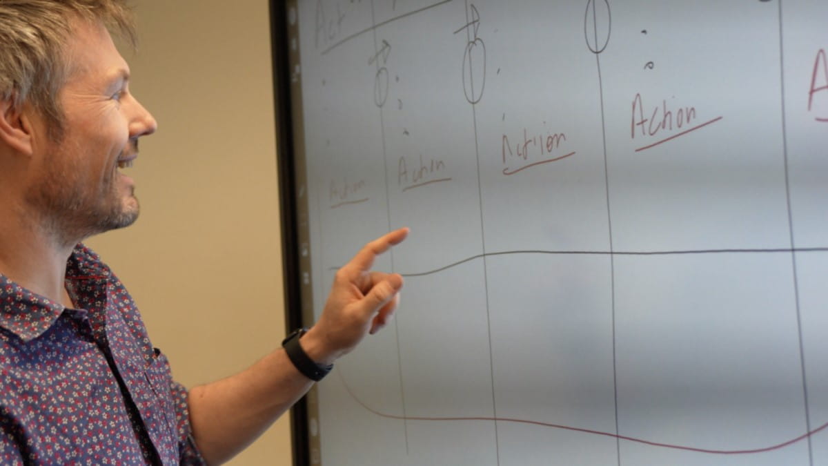 Dr Matthew Harrison, Senior Lecturer in Learning Intervention at the University of Melbourne interacting with a SMART Board.