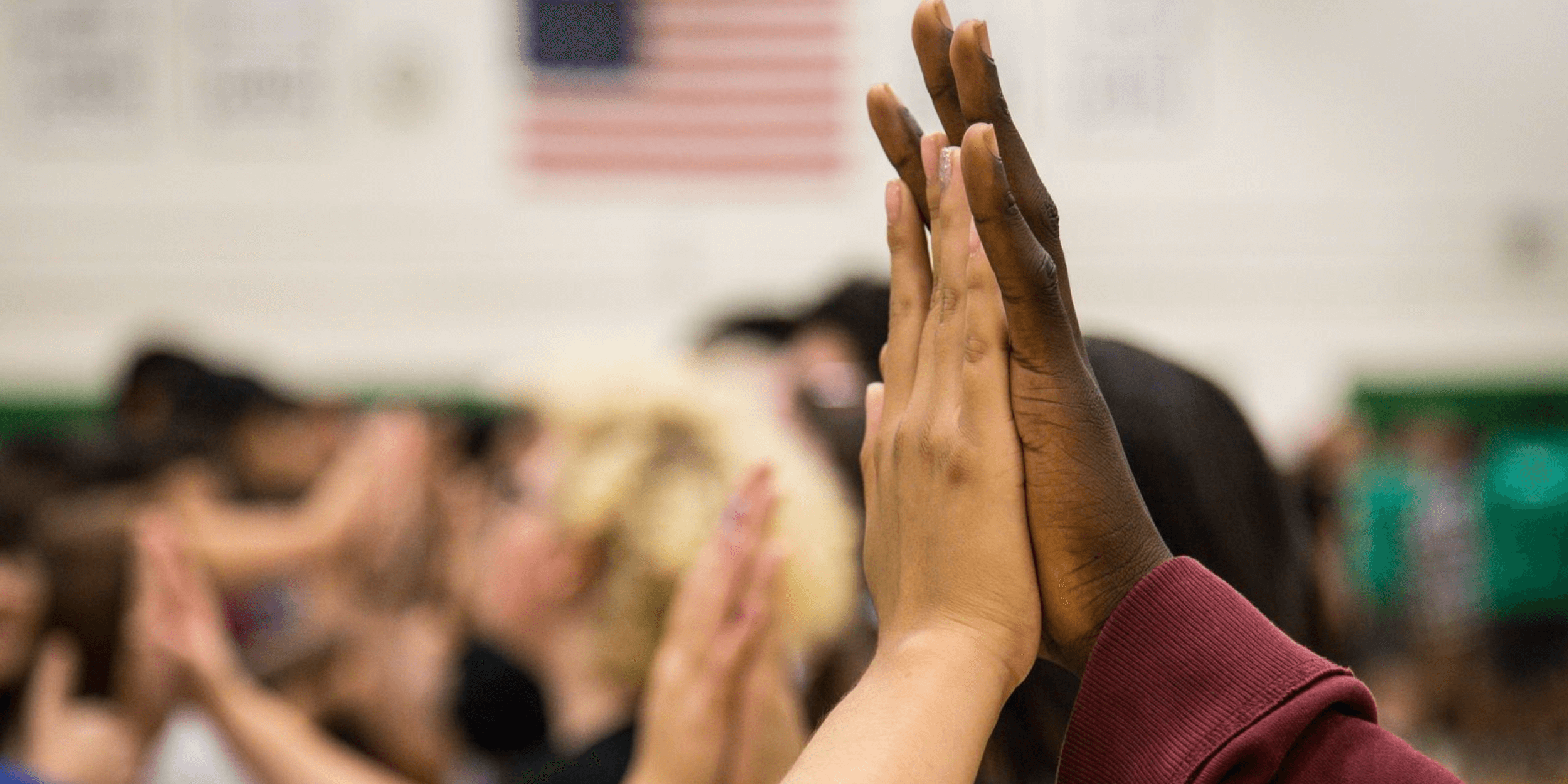 Two students hands in a high-five