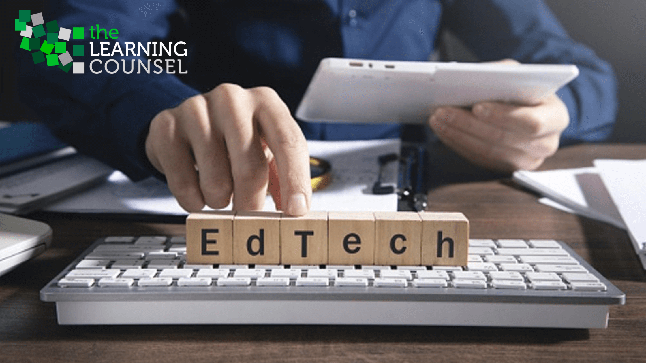 A man typing on a keyboard with scrabble letters reading EdTech in the foreground.