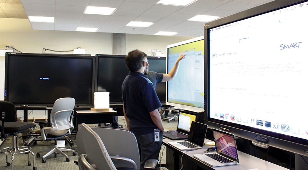 Person using a SMART board for work