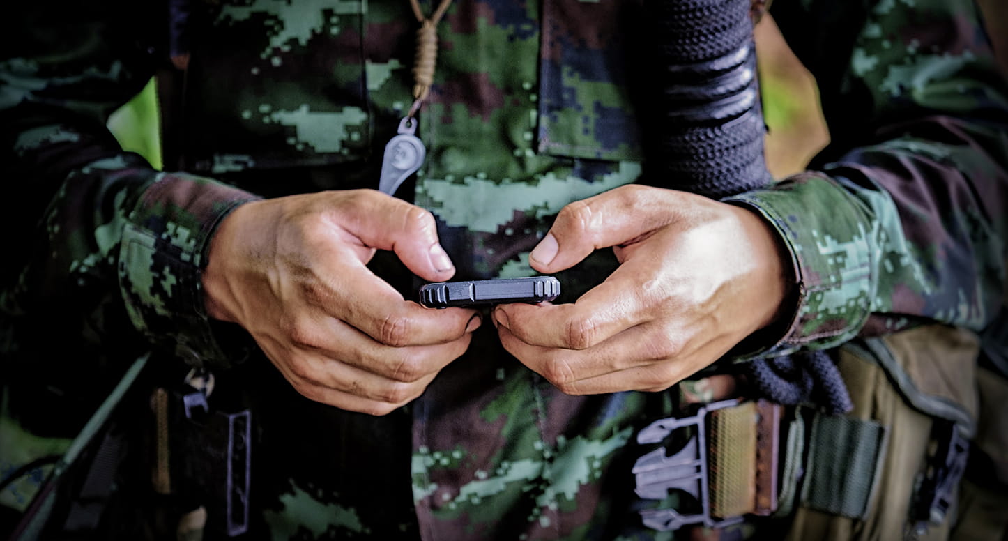 Military soldier using a cellphone