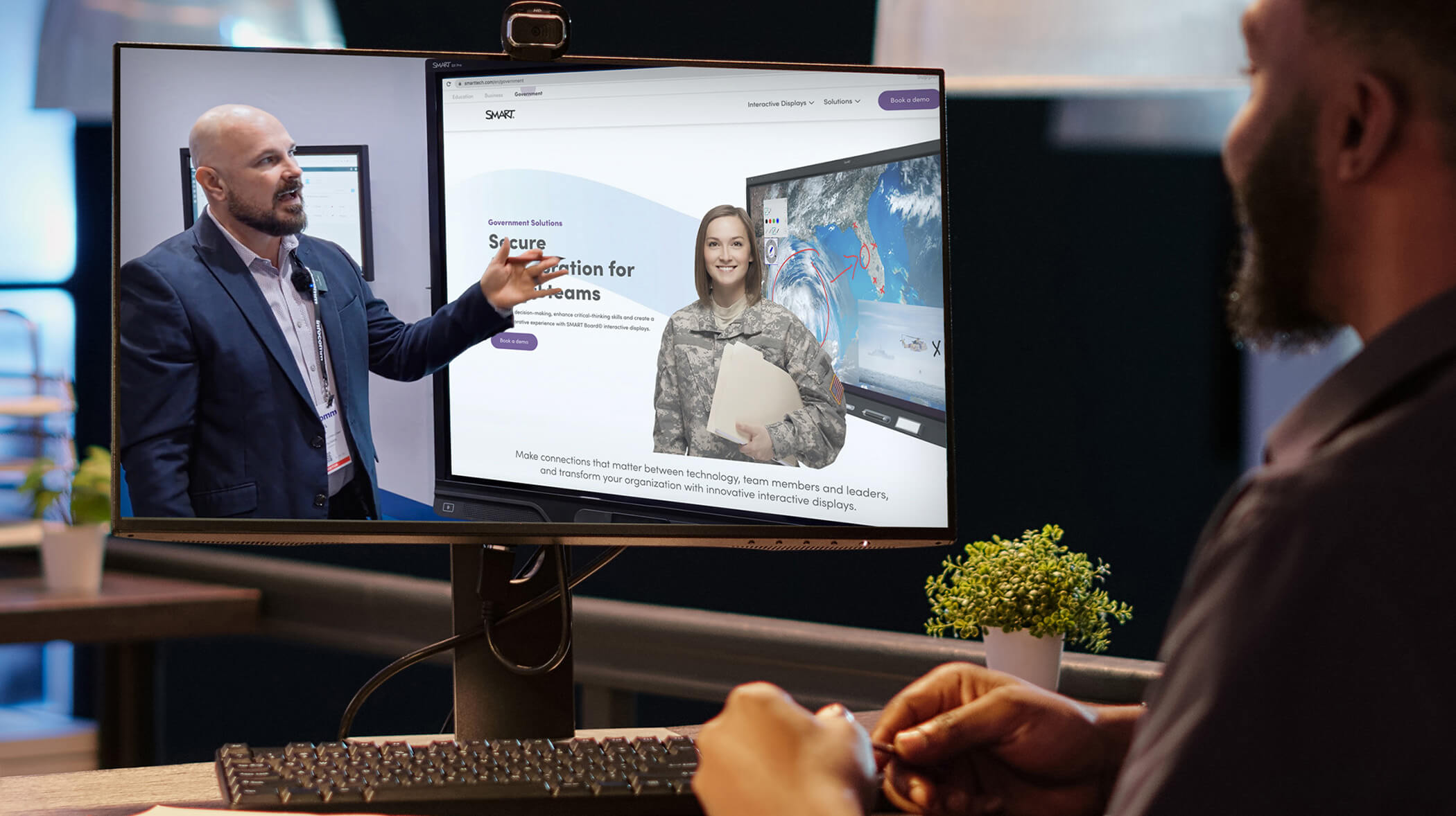 An individual attentively watching a presentation on his computer about SMART's Government initiatives.