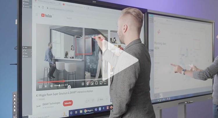 Business professional using a SMART Ink compatible interactive display to annotate over a live video conference, demonstrating the product's broad interoperability with Windows and Mac applications.