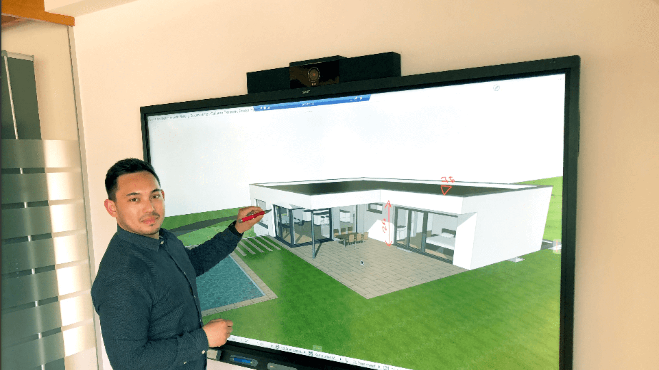 Owner of WachbergerBau, Werner Kopatsch, interacting with a 3D home rendering with a SMART 7086 series for business.