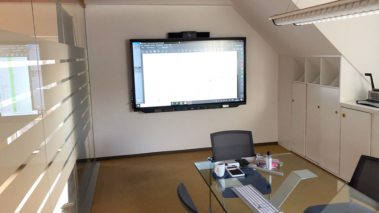 Plain office meeting room featuring a SMART Board interactive display for presentations and collaborative work.