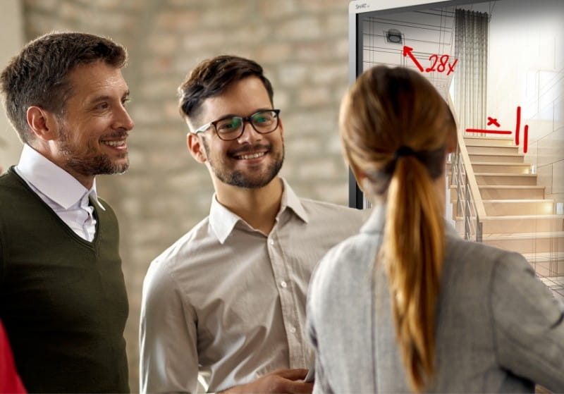 Three professionals engaging in a discussion, possibly during a break in a meeting, with a focus on collaboration and connection.