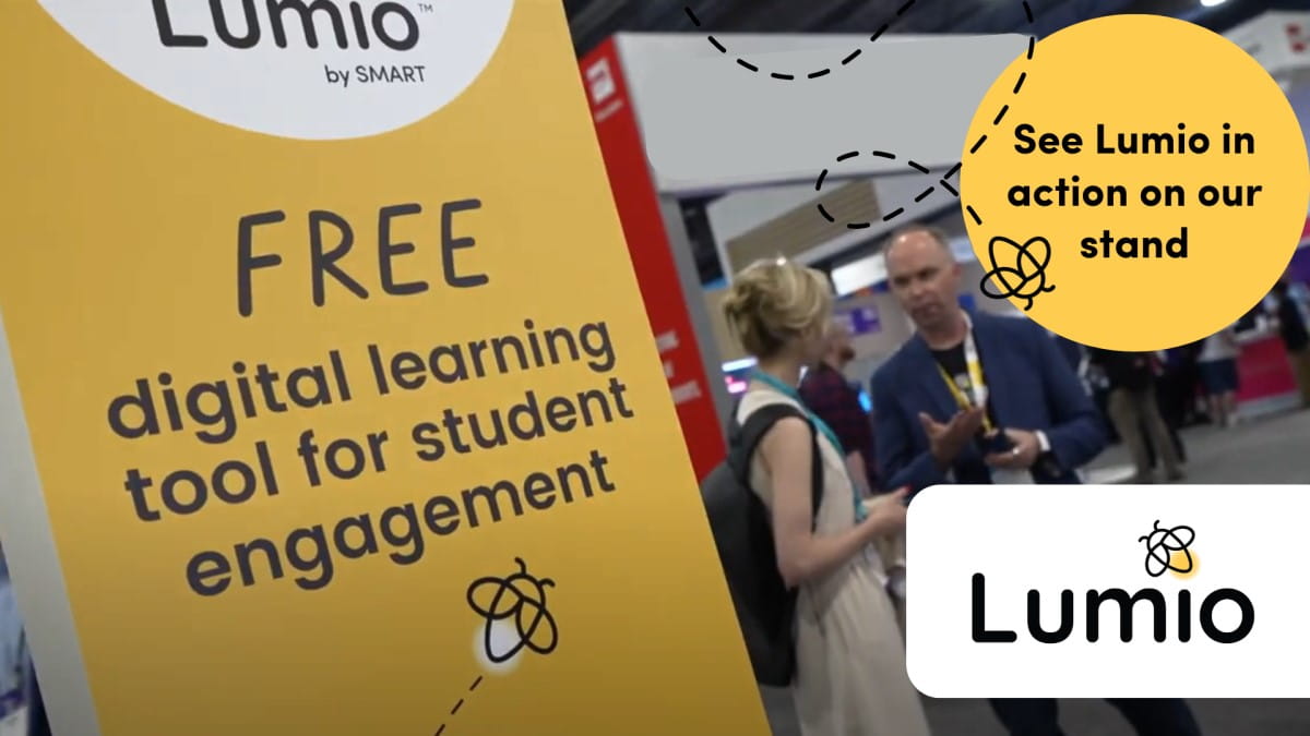 Lumio by SMART promotional stand at an event showcasing 'FREE digital learning tool for student engagement' with attendees and a representative in the background.
