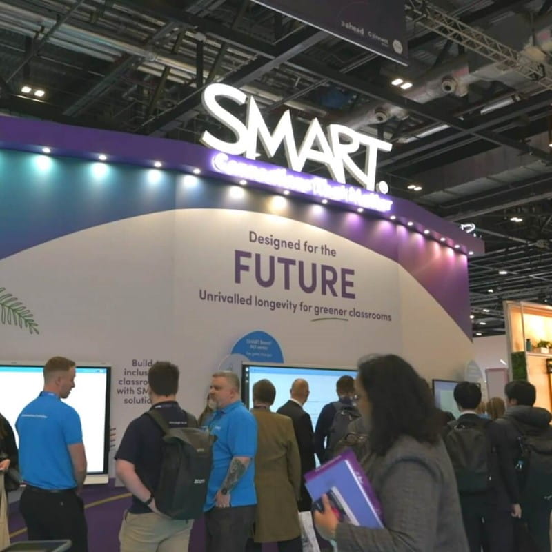 SMART Technologies booth at an expo with a banner reading "Designed for the FUTURE"