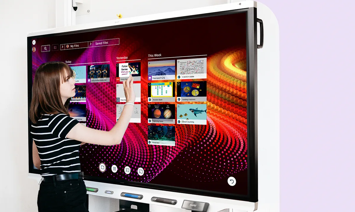 An image of a woman using the SMART Board 7000R, standing in front of the interactive display