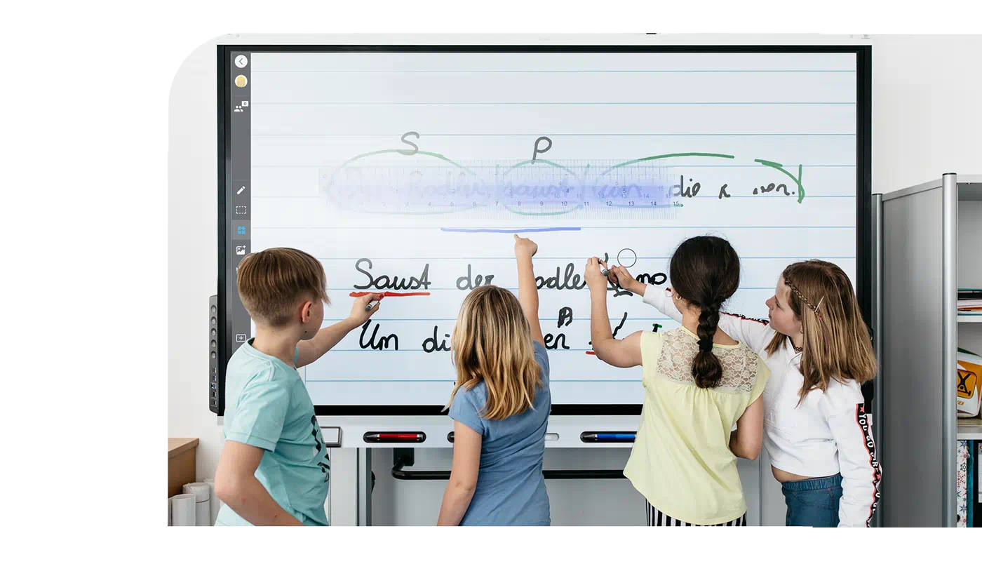An image showing a group of students gathered around a SMART board 7000R, actively engaged in an activity.
