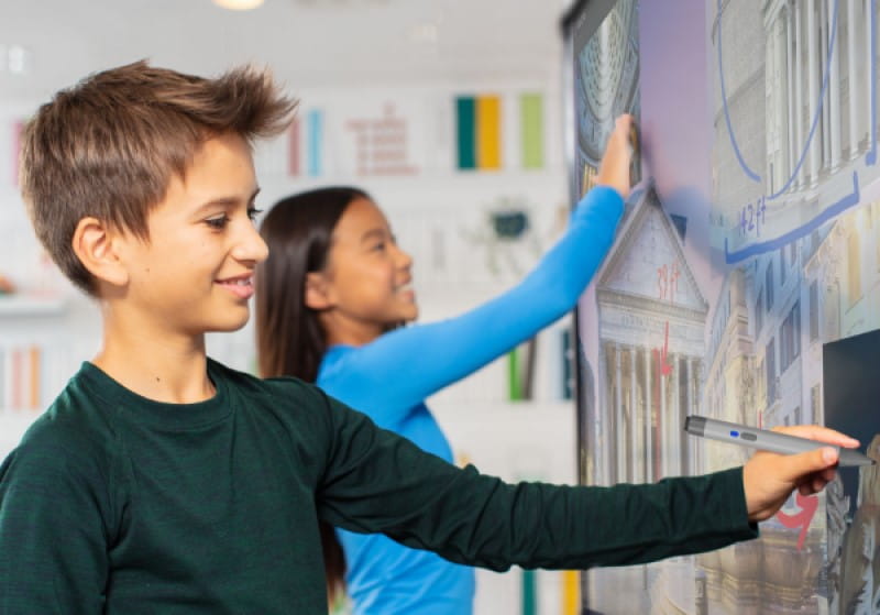 Young learners collaborating on a historical building analysis using the RX series SMART Board, enhancing their engagement with digital educational content.