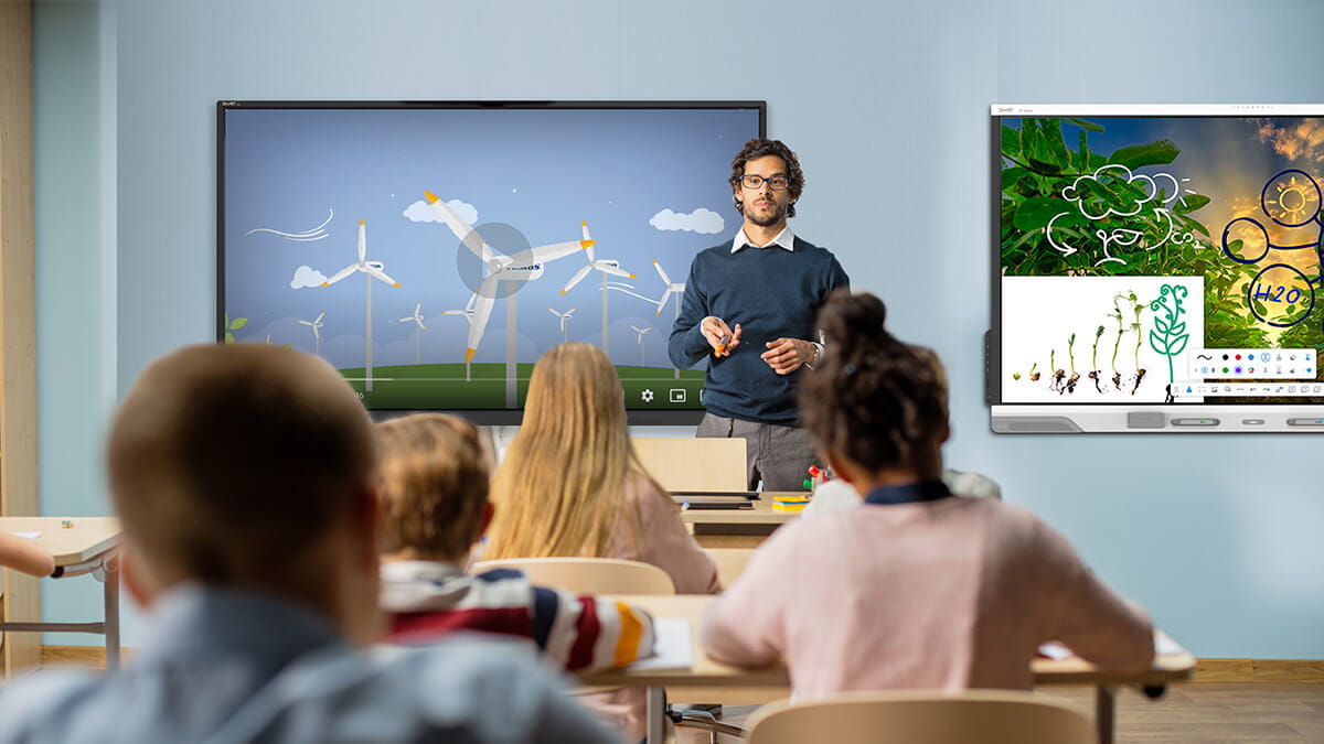 Teacher leading a lesson on renewable energy using a SMART Board NX series non-interactive display alongside a SMART Board RX series interactive display.
