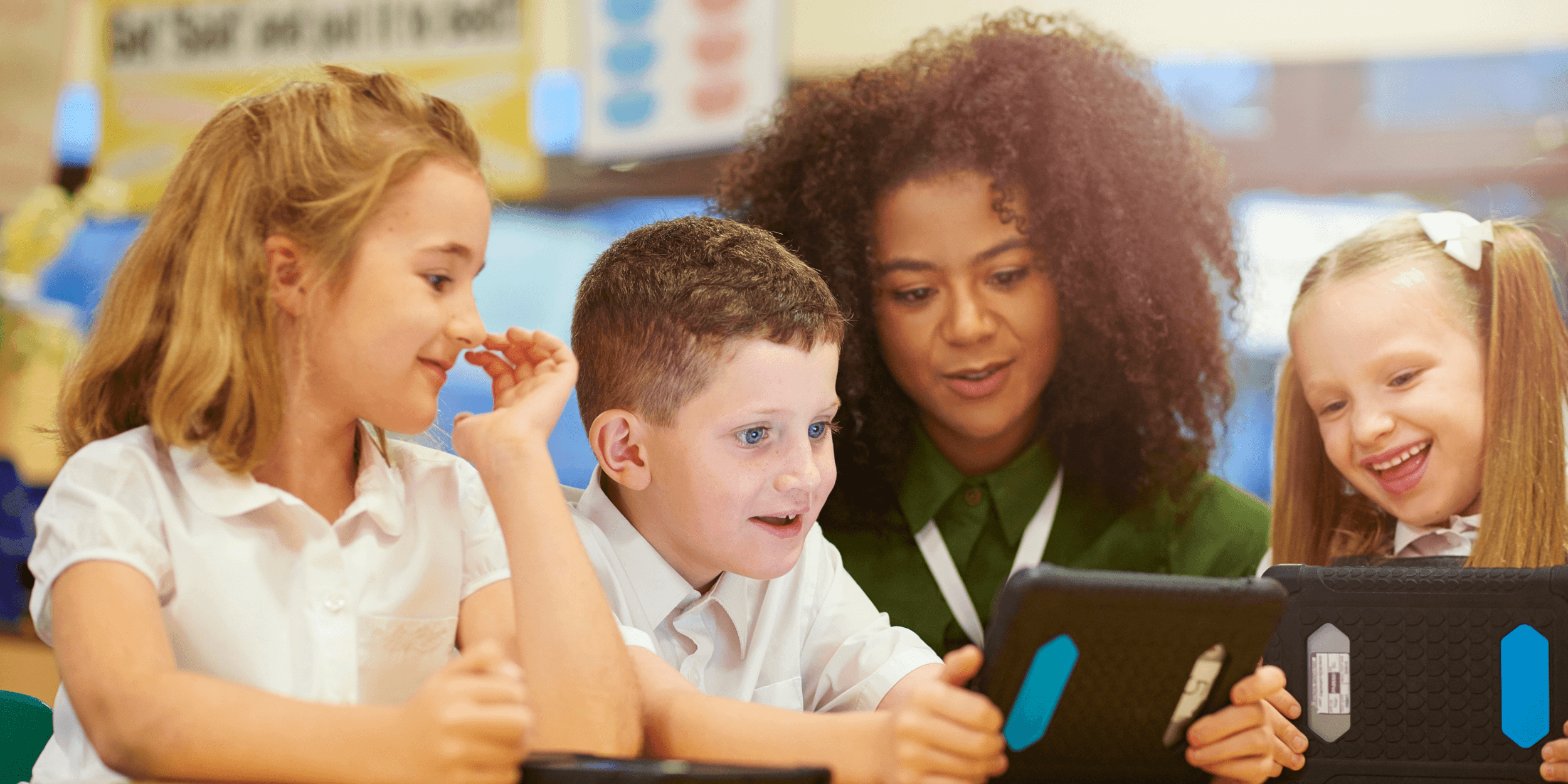 A teacher helping three students on their classroom tablets.