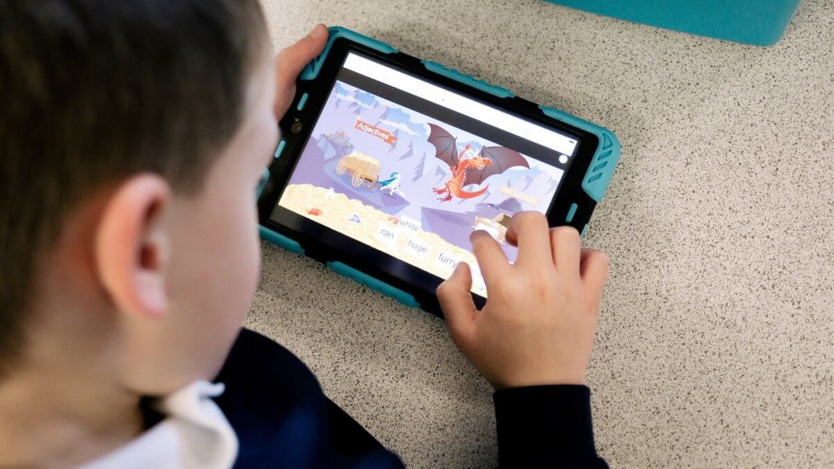 A student taking part in a Lumio activity on a tablet.