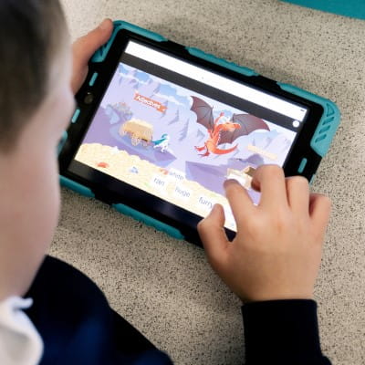 A student taking part in a Lumio activity on a tablet.