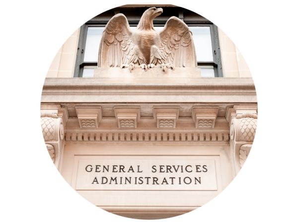 Historical building exterior with a prominent eagle figure and engraved words 'GENERAL SERVICES ADMINISTRATION' below.