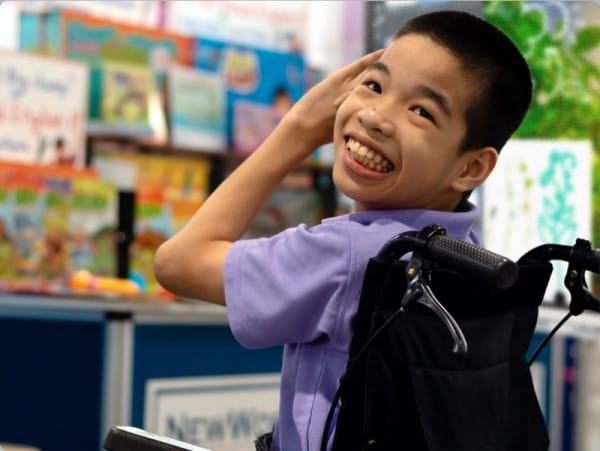 Joyful student in a classroom setting, exemplifying increased accessibility in learning for all students.