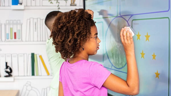 Student interacting with a SMART Board using a Tool Explorer cube