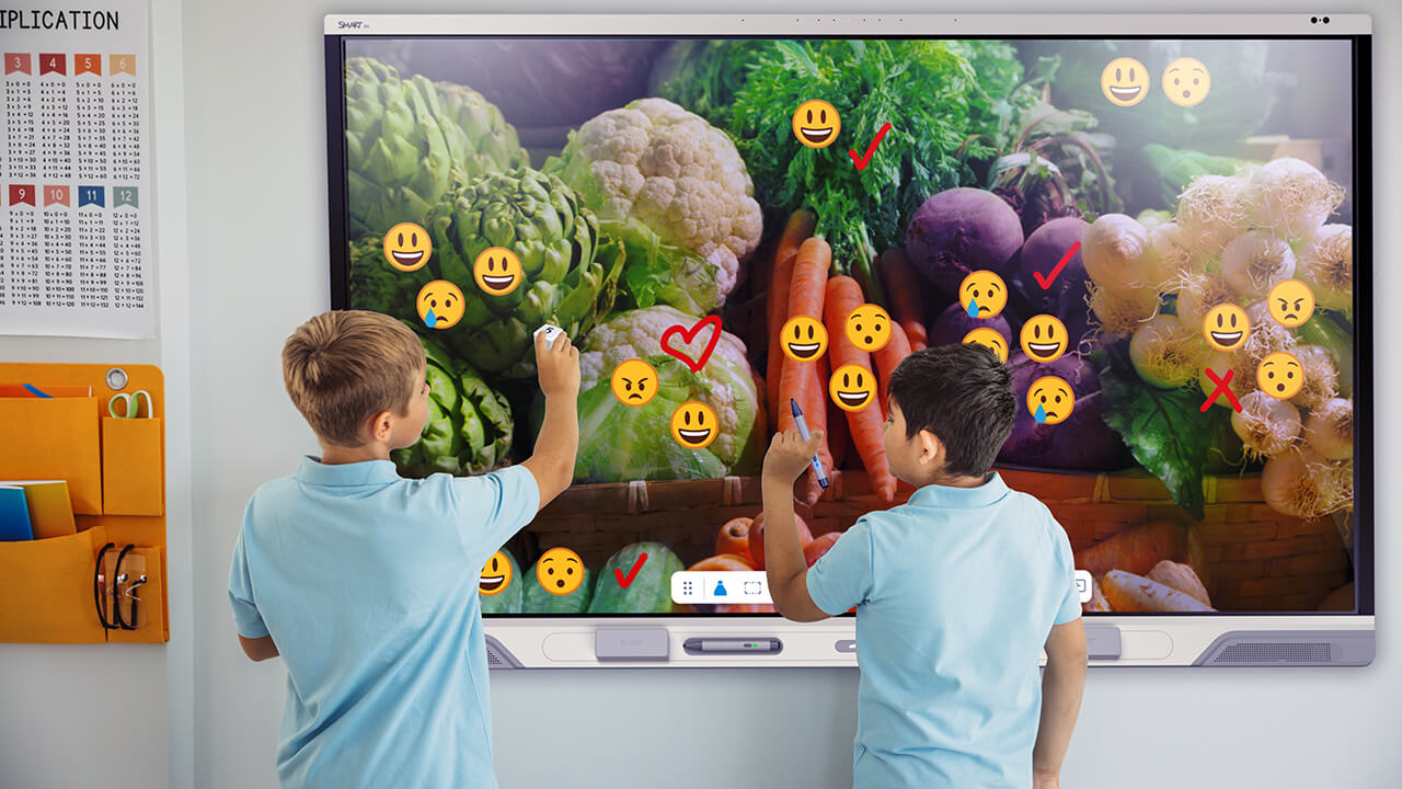 Children collaborating on a SMART Board together.