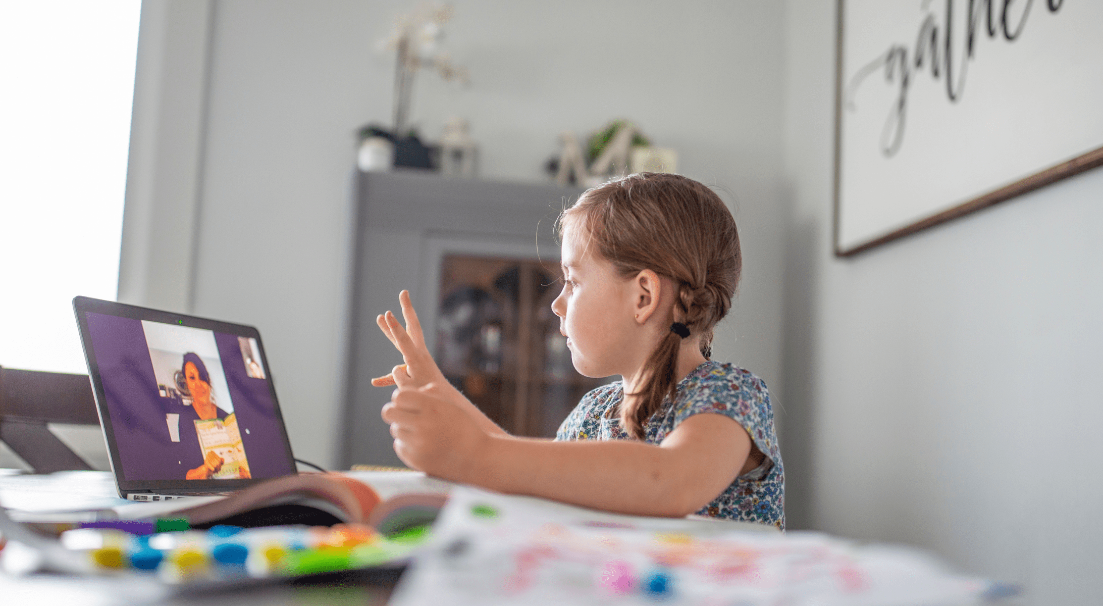 An elementary student participates in a remote classroom lesson during lockdown.