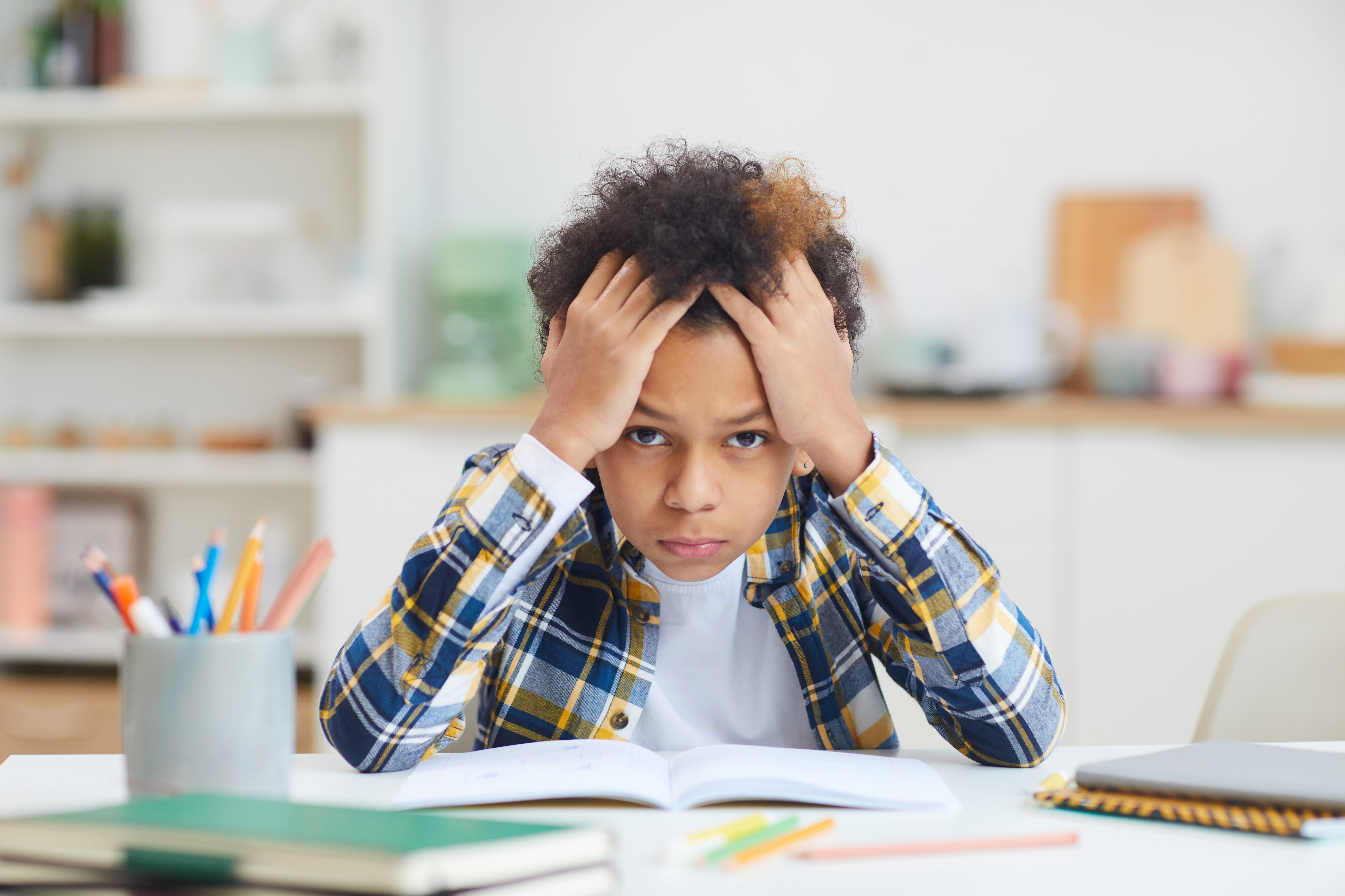 A student stressed and holding his head