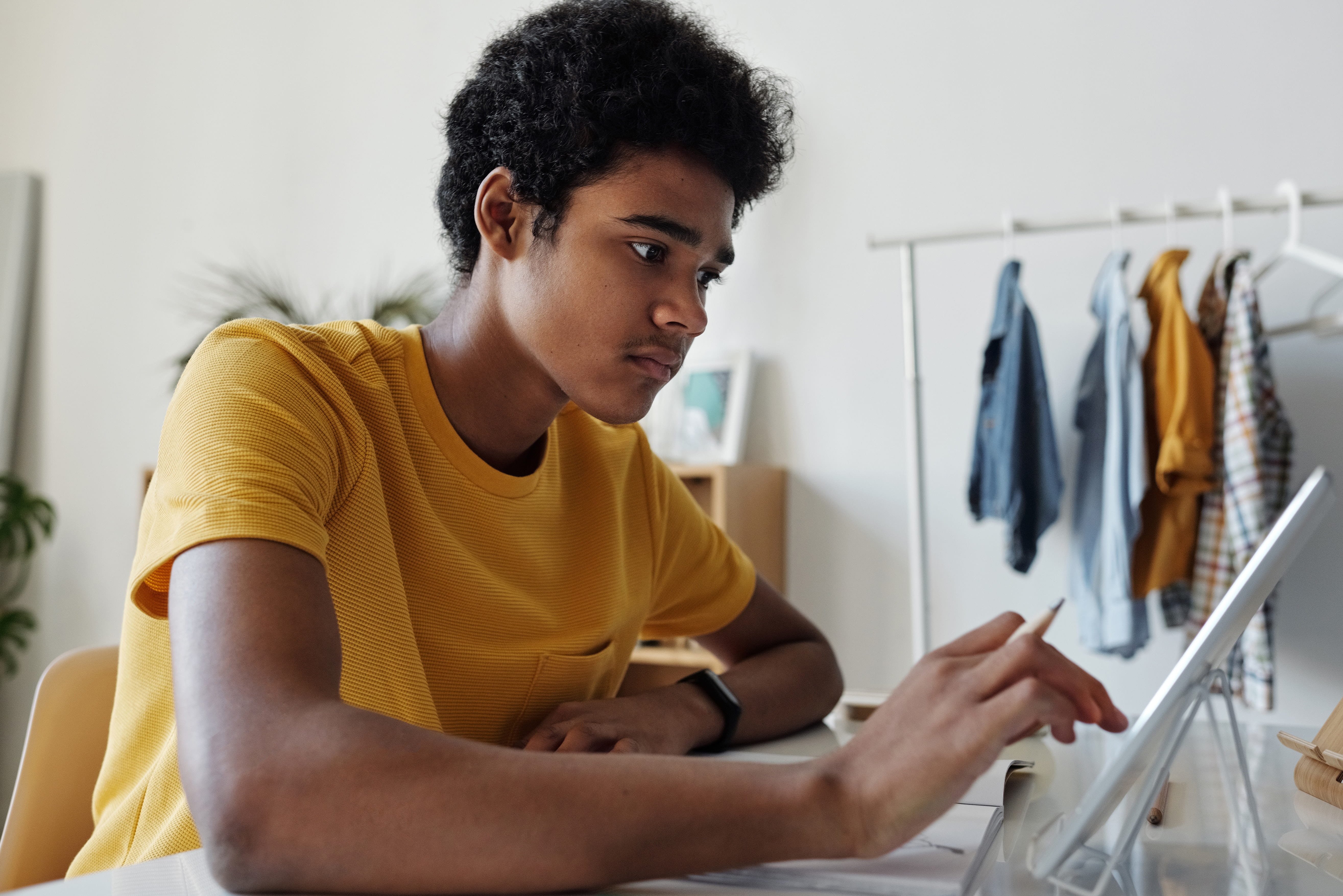 A student surrounded by thought bubbles symbolizing ideas