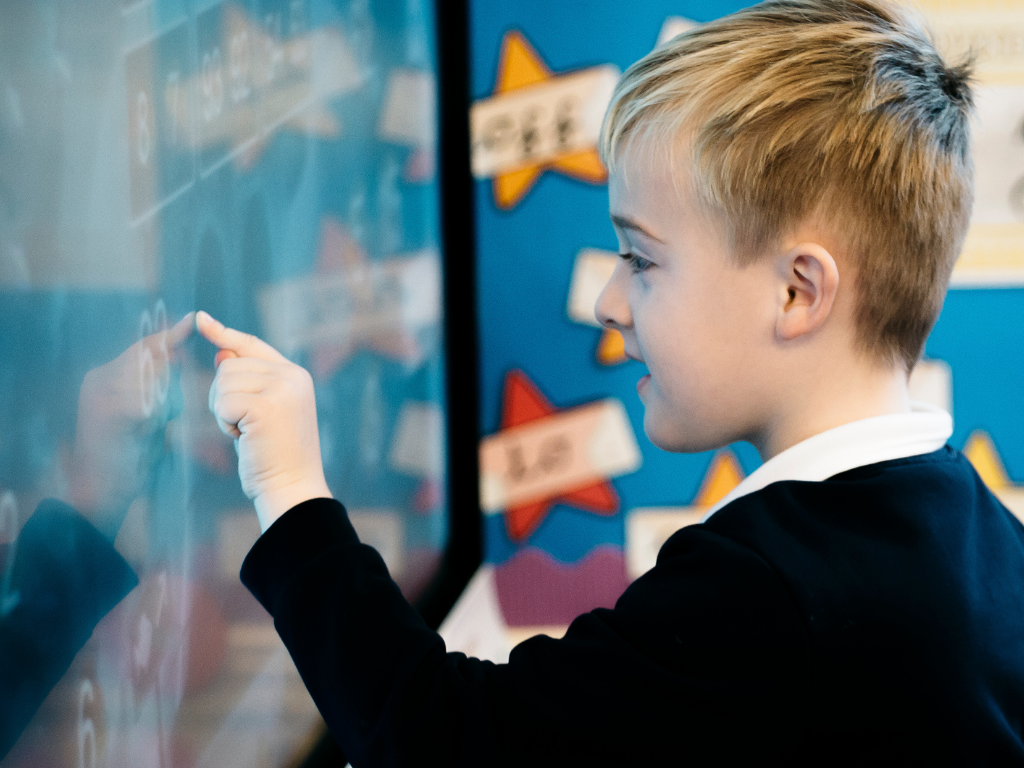 Young student playing an educational game on a SMART Display