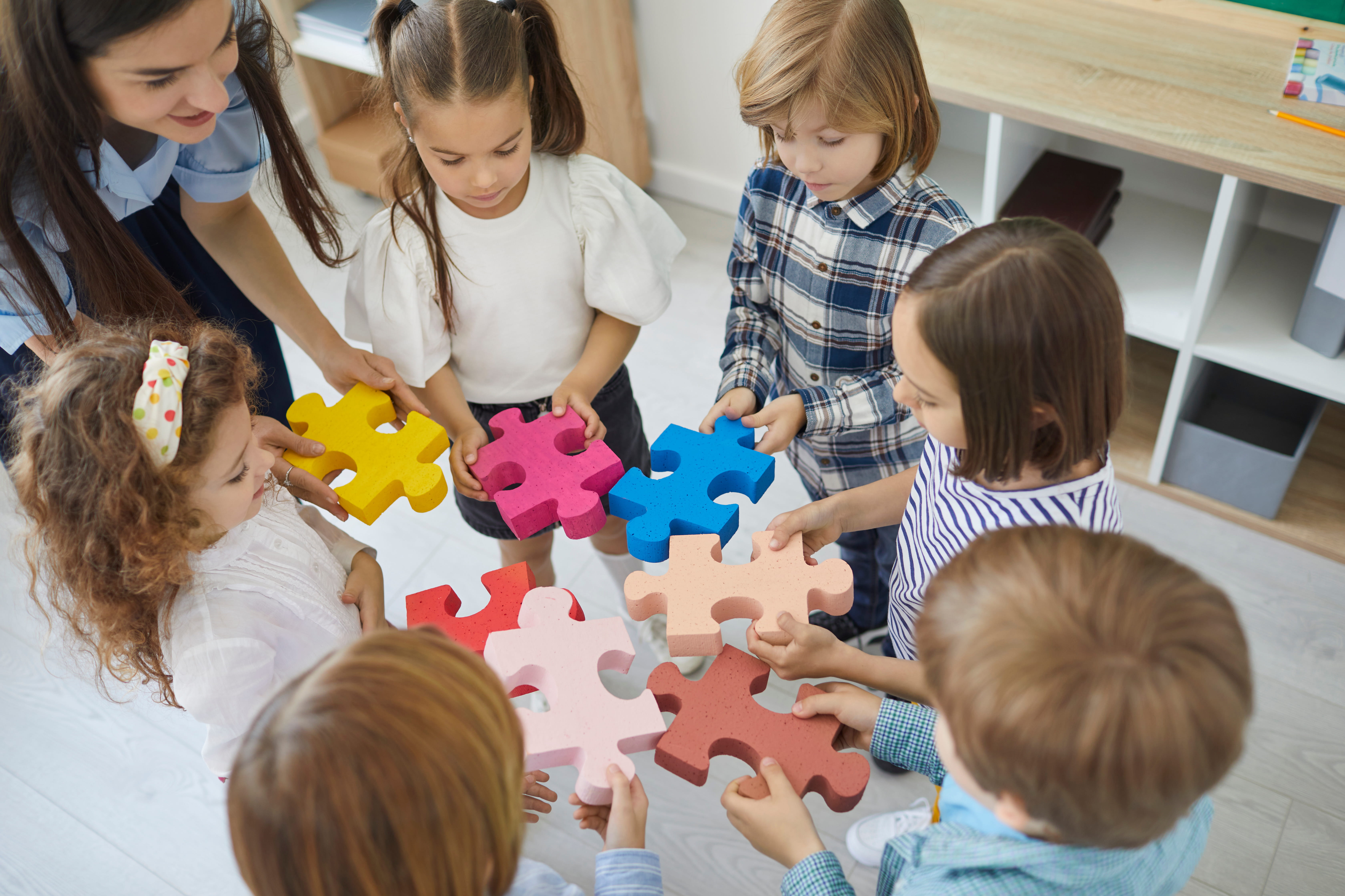 A group of students connecting puzzle pieces together