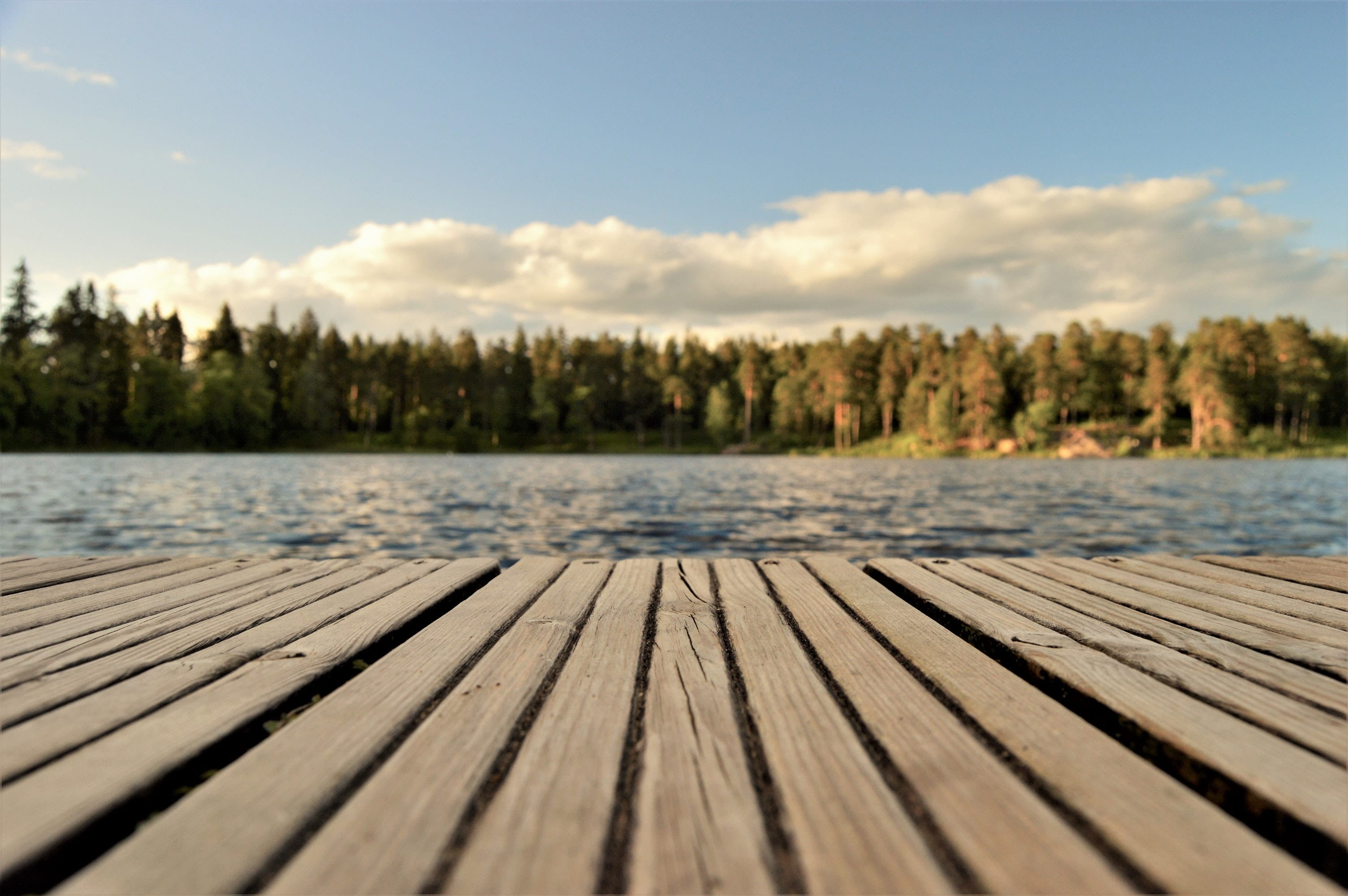 Landscape image of a deck and a lake.