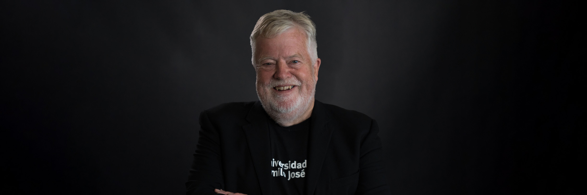 Stephen Heppell in front of a black background.