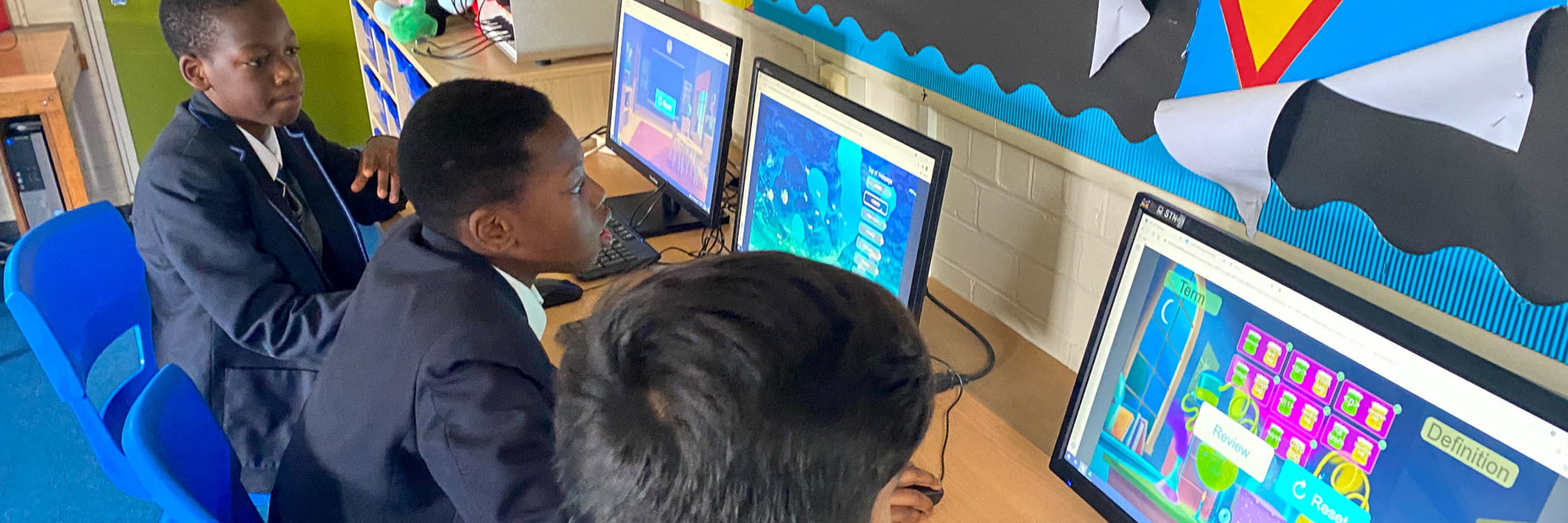 Three students engaging in game-based learning online.