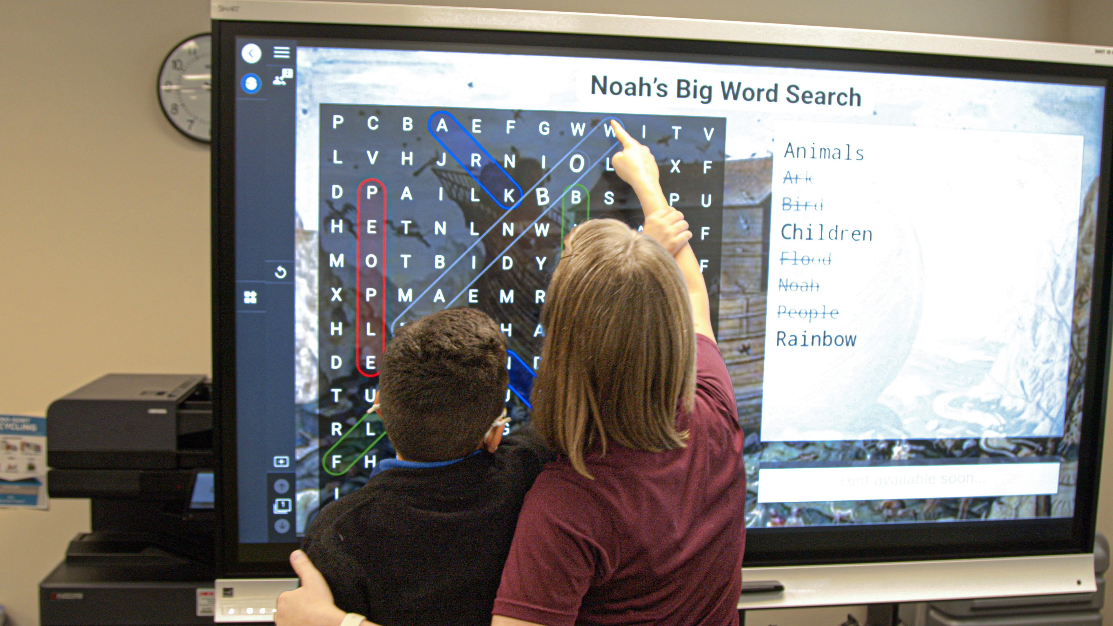 A student and teacher complete a game-based word search activity on Lumio. 
