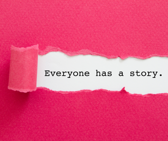 Pink piece of paper saying "everyone has a story"