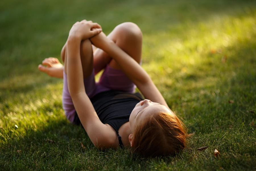 Young girl laying in the grass