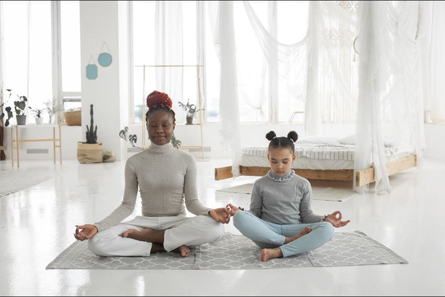 Mother and daughter doing a meditation together