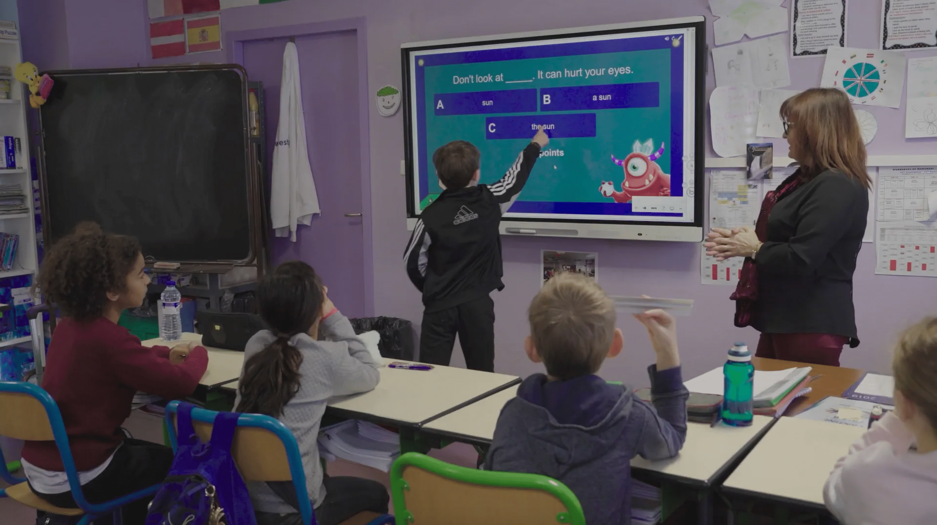 Students working on a SMART board