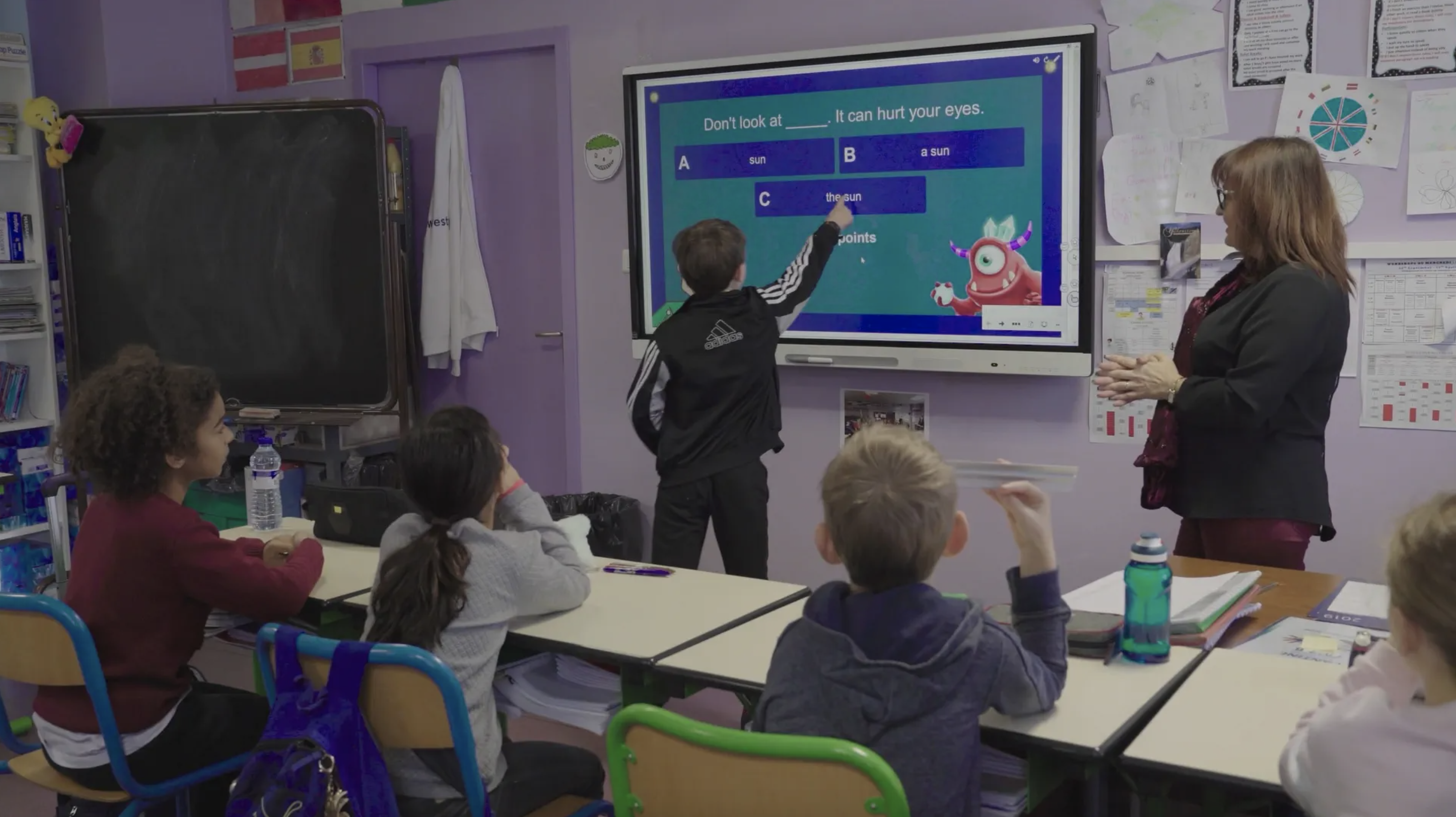 Students working on a SMART board