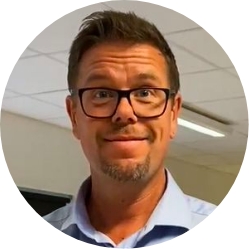 Close-up portrait of Ola Brorson, an English teacher and IT coach, smiling at the camera.