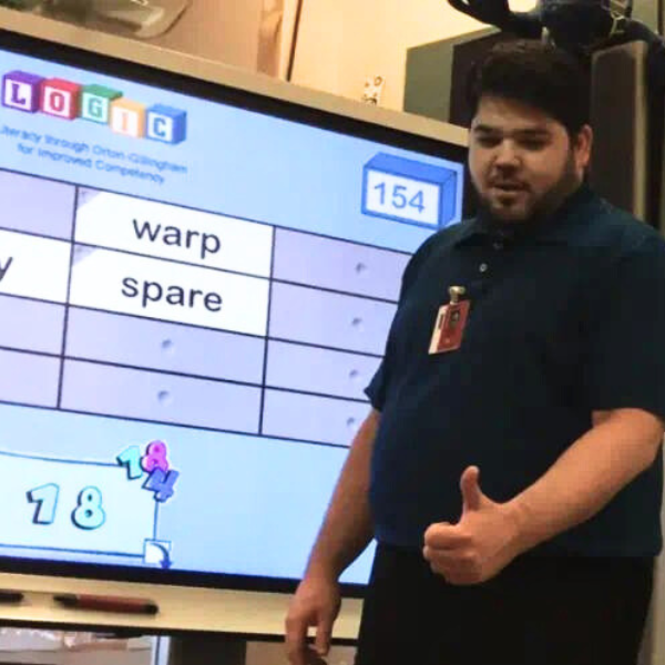 Educator, Bob Young, using a SMART Board to encourage students to use voice & choice.