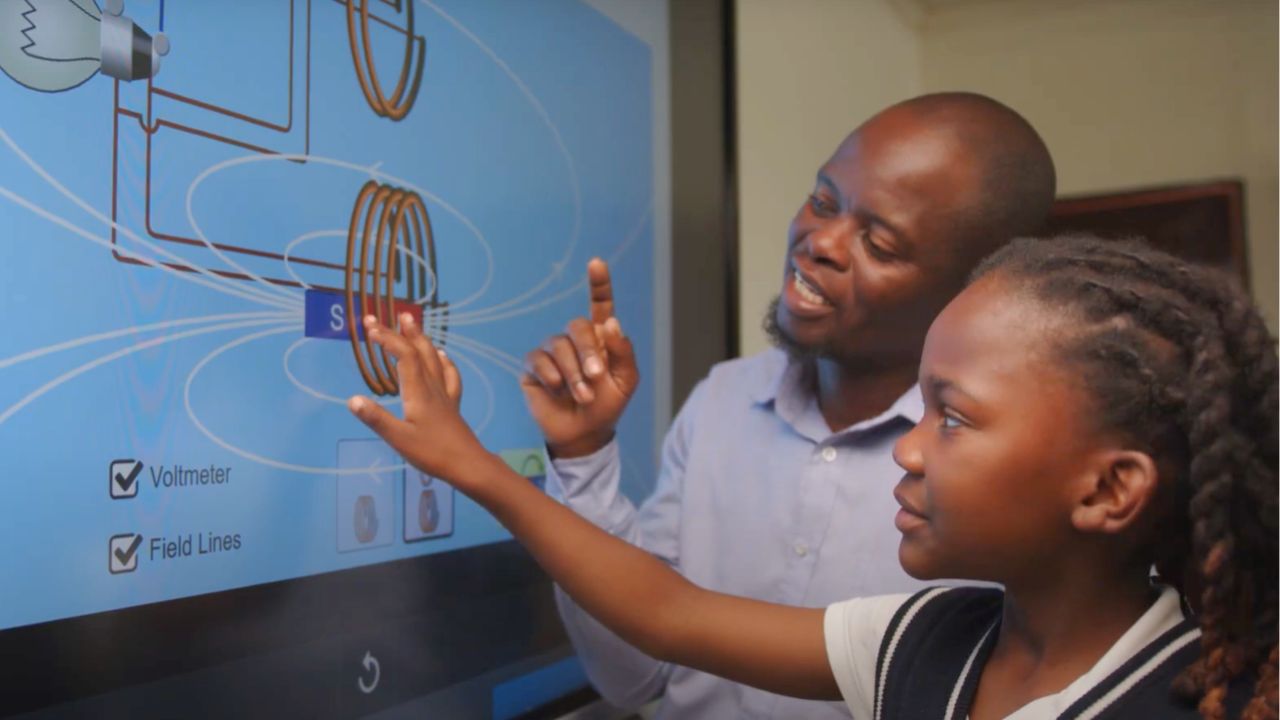 A teacher and student manipulating an element on the SMART Board at Delta Waters, Botswana. 