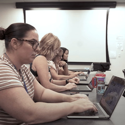 A group of students using their laptop