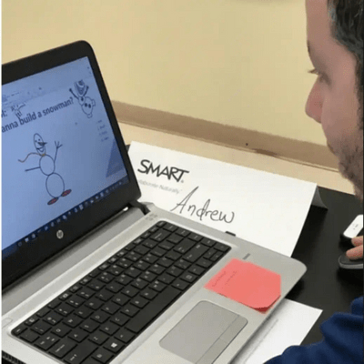 A teacher making an activity in his laptop.