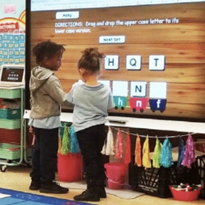 Students and teachers of the School District of Philadelphia interactive with SMART Displays in a classroom