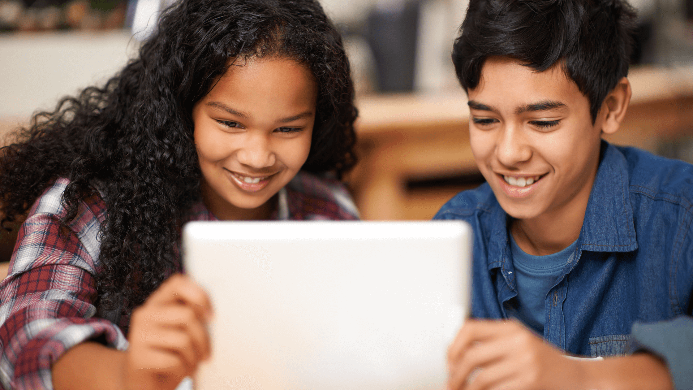 Two students working collaboratively on a tablet