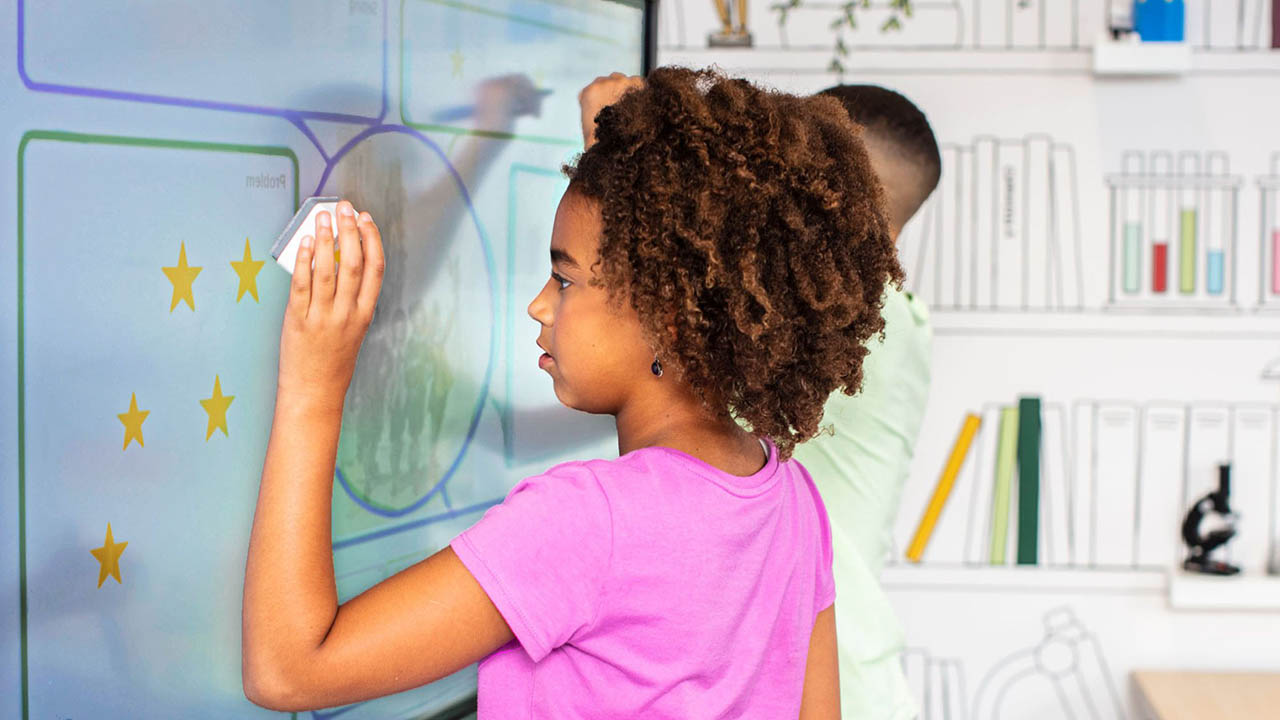 A student effortlessly stamping an image onto a SMART Board with a Tool Explorer Stamp.