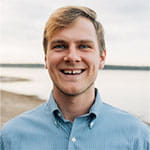 Portrait of Stanton Terrell smiling outdoors, wearing a light blue button-up shirt.