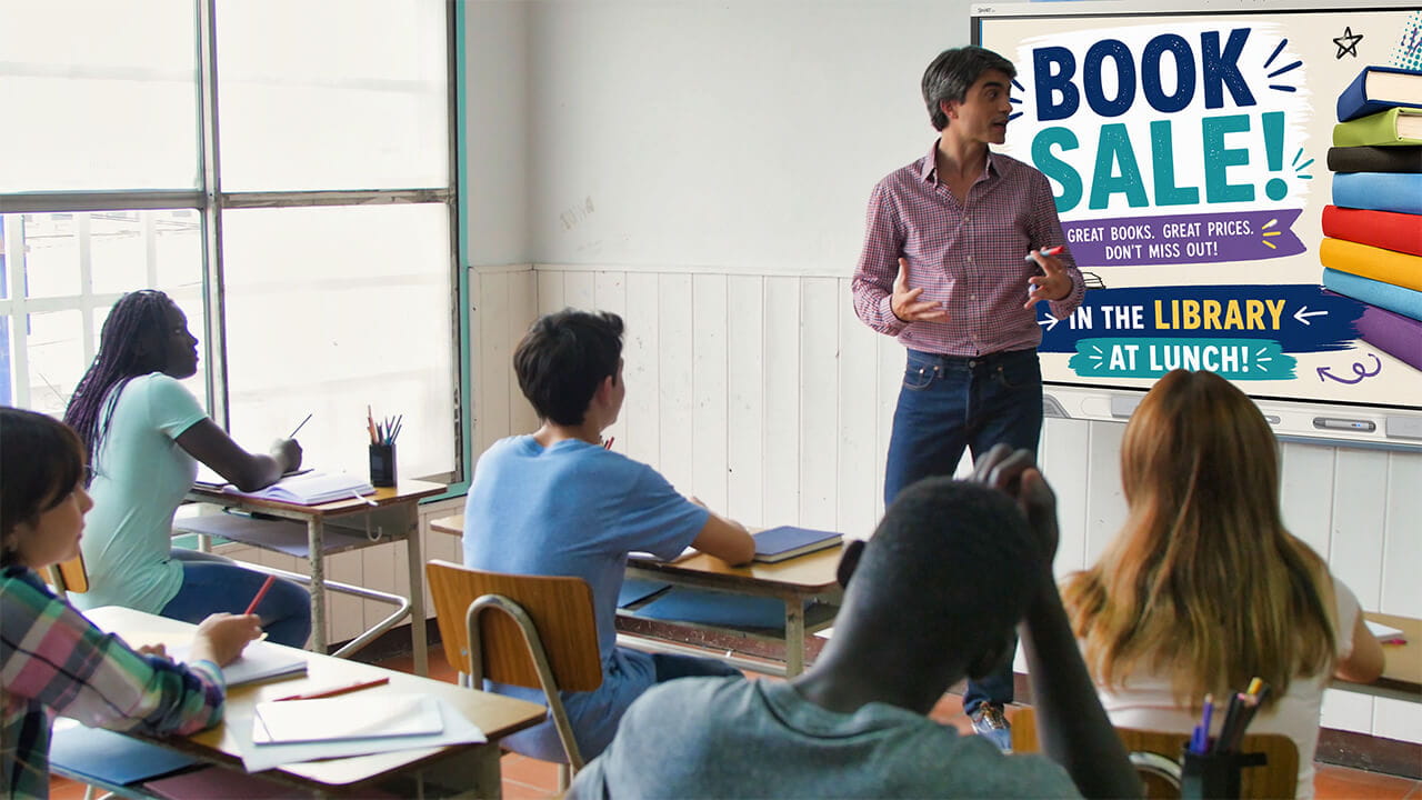 Digital signage promoting a school event displayed in a classroom.