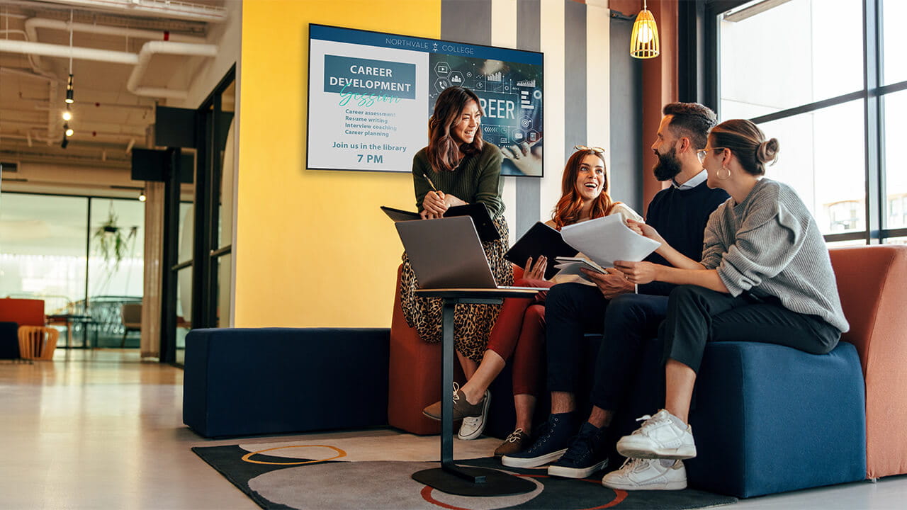 Digital signage promoting workplace events and professional development opportunities.