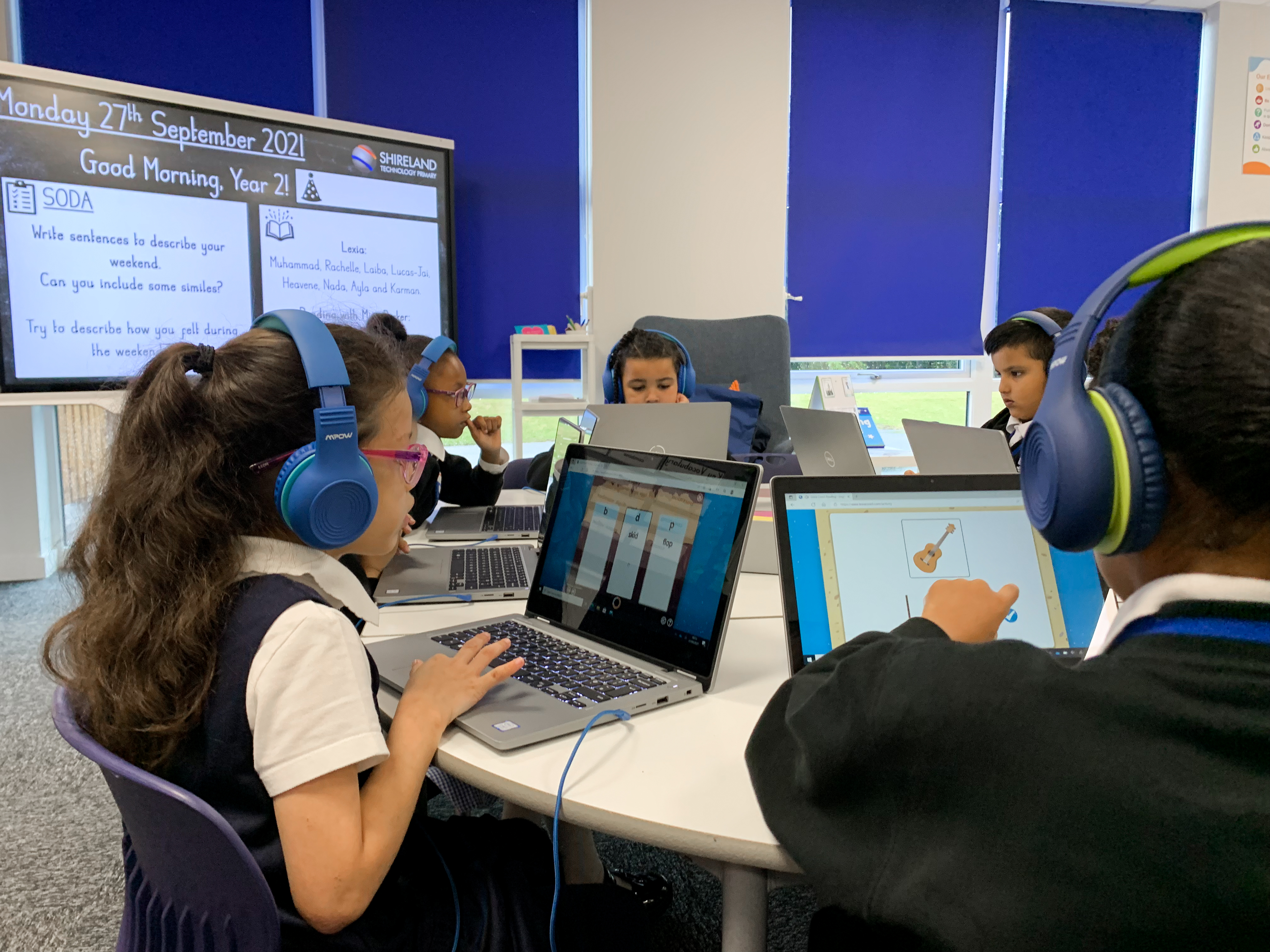 Students complete a lesson in Lumio on their personal devices.